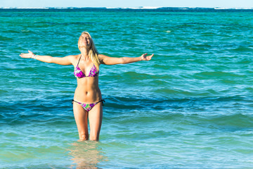 Sexy back of a beautiful woman on tropical beach in small sexy bikini