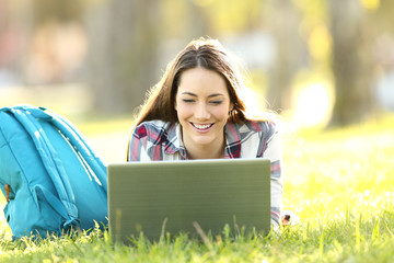Happy student watching on line content in a laptop