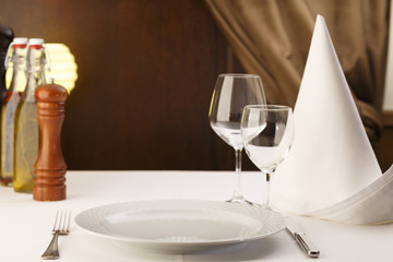 Meal setting arranged in elegant way, Wineglasses and silverware, Selective focus with soft light