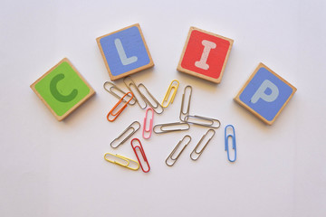 Clip, Word arrangement from wood alphabets pieces and stationary object.