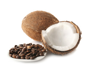 Saucer with coffee beans and coconuts on white background