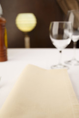 Napkin arranged in elegant setting, Wineglass in the background, Selective focus with soft light