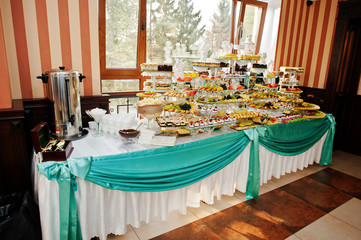 Fantastic wedding banquet table with awesome decor and delicious dishes.