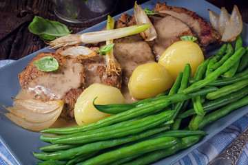 Beef medallions with caramelized beans and young potatoes