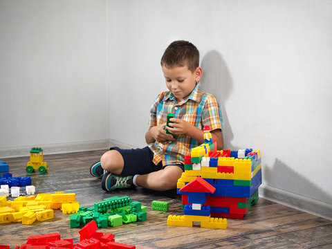 boy plays in the construction. Colorful toy designer, a lot of details