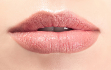 Closeup view of beautiful young woman with natural lips makeup