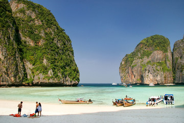 Tourists and longtail boats at Maya Bay on Phi Phi Leh Island, Krabi Province, Thailand