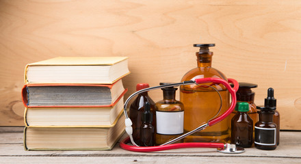 Medical education concept - books, pharmacy bottles and stethoscope