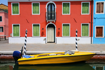 Fototapeta na wymiar Boat anchored in canal in Burano, Venice, Italy
