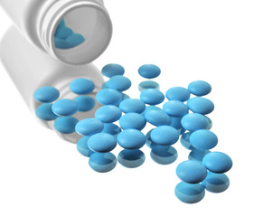 Plastic container and pills on glass background