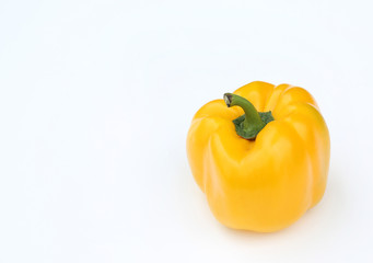 Yellow bell pepper on wood background.