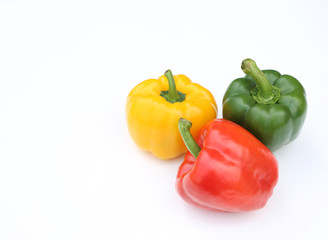 Green, red and yellow bell pepper isolated on white background.