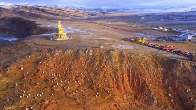 Aerial view of big Buddha Statue on the hill at Yarchen Gar Monastery in Sichuan, China