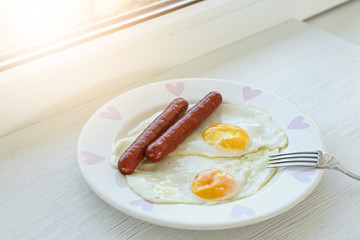 Delicious breakfast with over easy eggs on windowsill