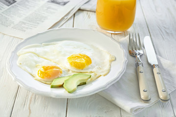 Delicious breakfast with over easy eggs on kitchen table