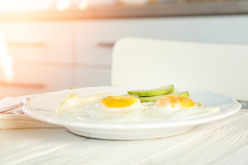 Delicious breakfast with over easy eggs on kitchen table