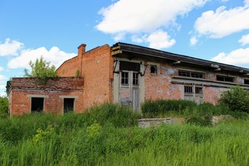 Fototapeta na wymiar An old abandoned building of warehouse for mineral fertilizers in June 2017, Arsenyevo, Russia.