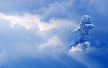 Cupid with arrow over cloudy sky