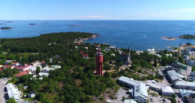 Water tower, Cinema 4k aerial view around the red watertower, revealing Hanko city, on Hango regatta day, in Uusimaa, Finland