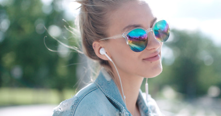 Young woman with headphones enjoying time in a city.