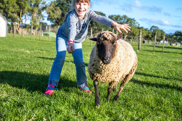young kids taking care of animals on a farm