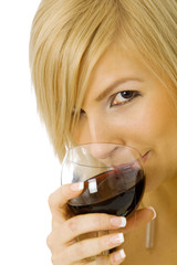 Young blond woman drinking wine