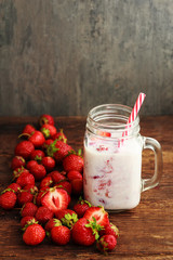 smoothie strawberry or milkshake in jar and basket on old rustic background