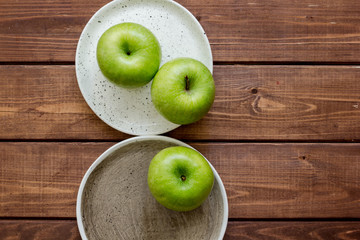 Healthy green food with apples on plates wooden background top view mock up