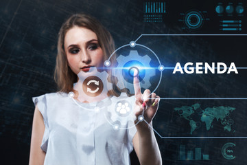 The concept of business, technology, the Internet and the network. A young entrepreneur working on a virtual screen of the future and sees the inscription: Agenda