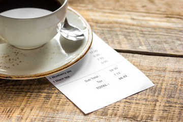 paying check for lunch with card wooden table background