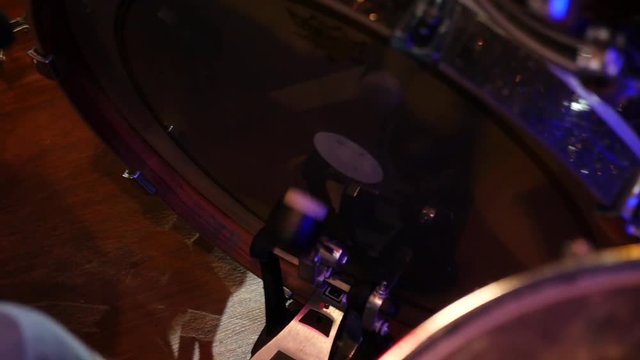 man playing bass drum, pressing his foot on pedal on live concert Slow motion