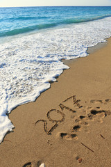 Number 2017 written on seashore sand