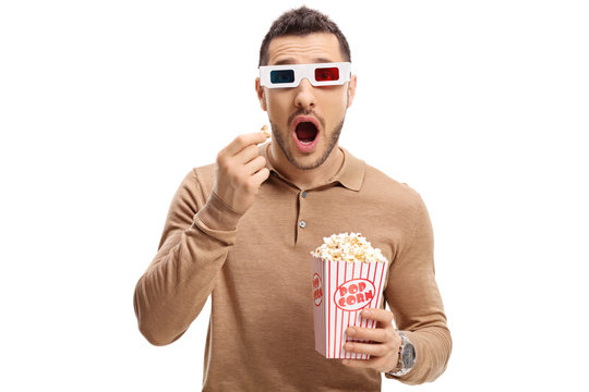 Scared guy with a pair of 3D glasses and popcorn