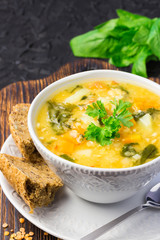 Winter detox Moroccan sweet potato lentil soup on dark slate background.