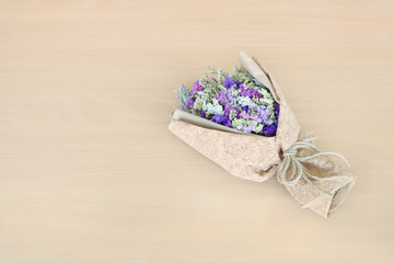 Statice flower bouquet on wooden background. free space for design