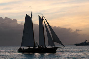Two masted sailboat, cruising at dusk in Key West harbor.