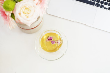  Freelance fashion femininity workspace in flat lay style with flowers, rose tea, notebooks 