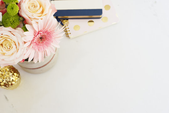  Freelance fashion femininity workspace in flat lay style with flowers, rose tea, notebooks 