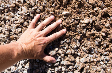 Building crushed stone with sand in hand