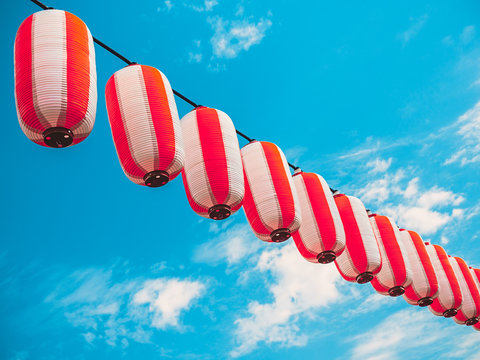 Paper Red-white Japanese Lanterns Chochin Hanging On Blue Sky Background