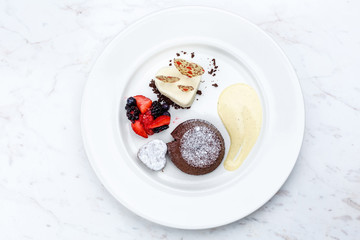 Chocolate fondant lava cake with ice cream strawberries and berries