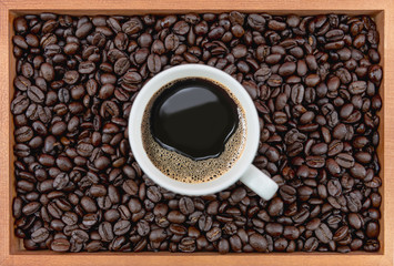 Coffee cup and coffee beans in box