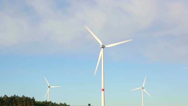 Windmill propellers spinning. Green energy generation.
