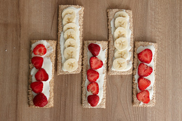 Fruit dessert. Fruits sliced on bread (cookies). View from above. Baban, strawberry. Healthy food.