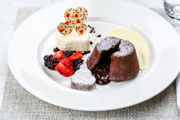 Chocolate fondant lava cake with ice cream strawberries and berries