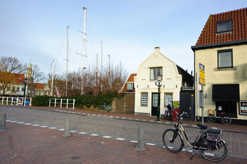 Fototapeta na wymiar Street in Enkhuizen - old city in Netherlands with bycicle near the road