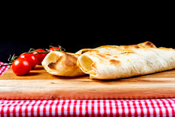 Mexican fajita wraps with grilled chicken fillet and fresh vegetables