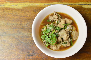 boiled chop chicken fish sauce soup topping parsley and spring onion on bowl