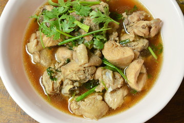 boiled chop chicken fish sauce soup topping parsley and spring onion on bowl