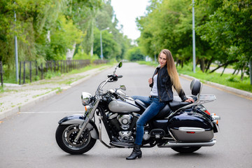 Naklejka na ściany i meble Beautiful girl on a motorcycle.